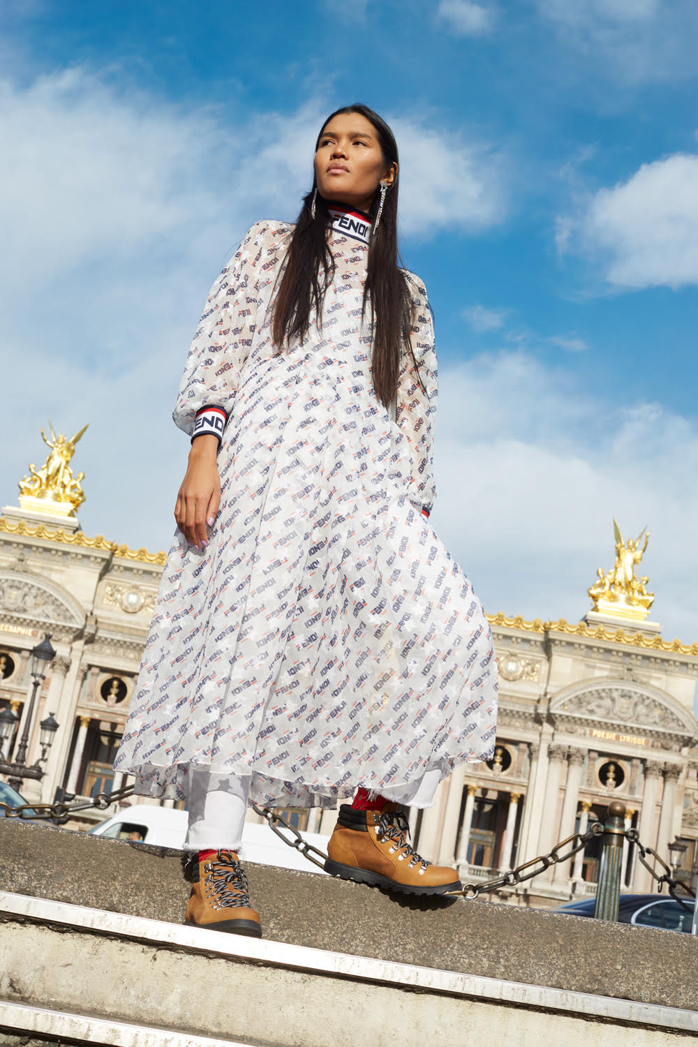 Printed silk dress, Fendi. Denim trousers, Vintage. Red socks, Wolford. Strass and metal earrings, Justine Clenquet. Leather hiking boots, Sorel